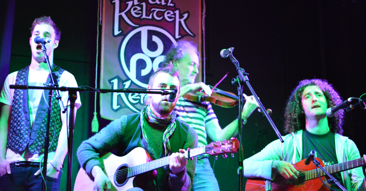 A group of musicians singing and playing instruments