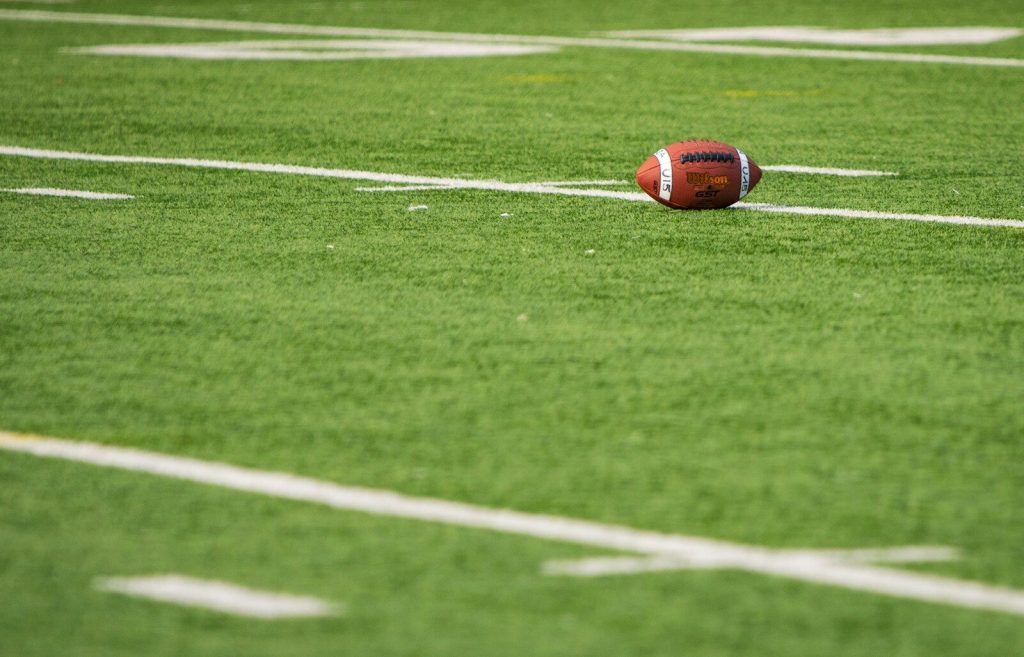 A football laying on a football field
