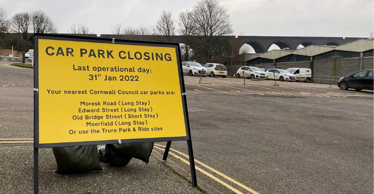 Sign on a road which says 'Car Park Closing - last operational day 31 Jan 2022'