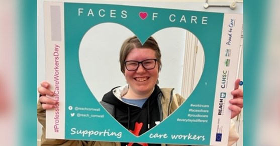 Icelyn is holding a heart shaped frame around her face that says Faces of Care