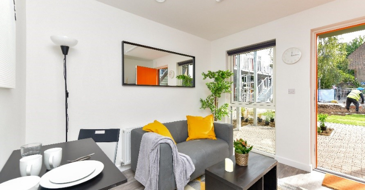 A living room with a table, chairs and sofa