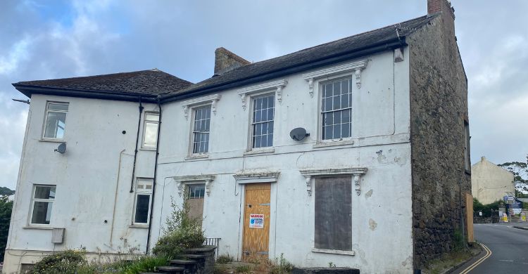 Image shows a large disused building