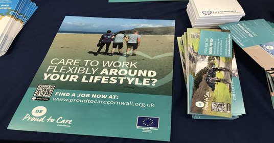 Poster and bookmarks on a table advertising Proud to Care