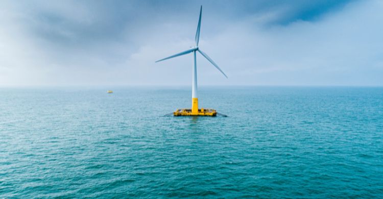 Photo shows a wind turbine floating in water
