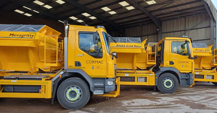 Image shows three yellow gritters in a row