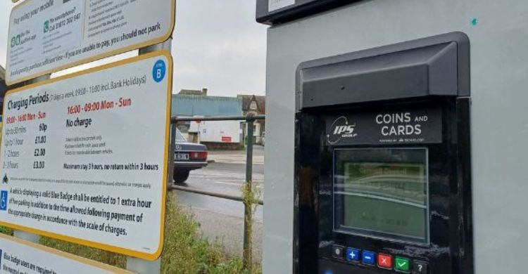 Image shows a car park machine and tariff board