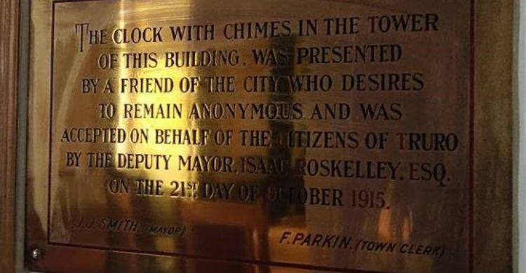 A bronze plaque commemorating Truro Clock Tower - the plaque reads 'The Clock with chimes in the tower of this building was presented by a friend of the city who desires to remain anonymous and was accepted on behalf of the citizens of Truro by the deputy mayor Isaac Roskelley Esq on the 21st day of October 1915'