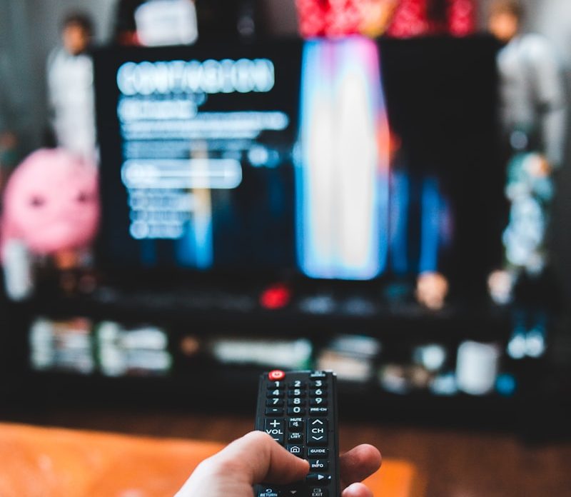 person holding black remote control