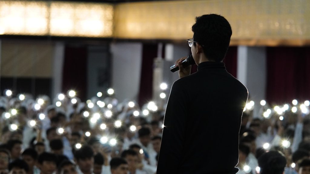 a man standing in front of a crowd of people